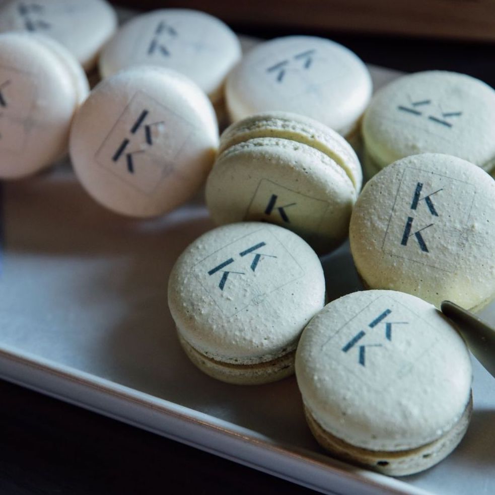 Custom printed macarons for Events by K Kremer that feature custom macarons in various flavors with the Events by K Kremer logo. Created and printed by Maddie About Cake.